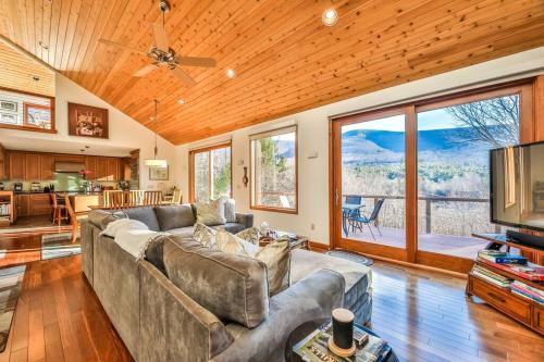 a living room with a couch and a large window at Mountain house w/ stunning views & gourmet kitchen in Maplecrest