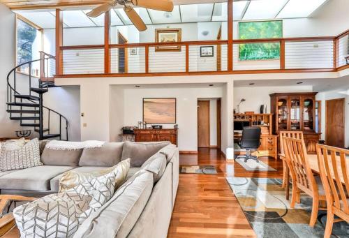 a living room with a couch and a staircase at Mountain house w/ stunning views & gourmet kitchen in Maplecrest