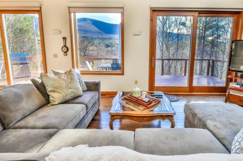 a living room with two couches and a coffee table at Mountain house w/ stunning views & gourmet kitchen in Maplecrest