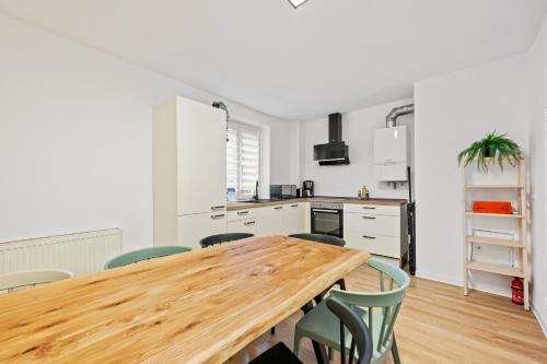 a kitchen with a wooden table and chairs at Sali Homes - Neuenstadt am Kocher in Neuenstadt am Kocher