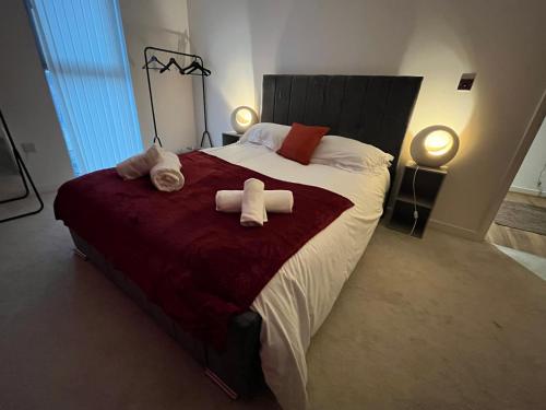 a bedroom with a large bed with towels on it at Central Darlington Large Penthouse Apartment in Darlington
