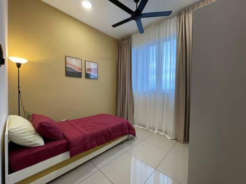 a bedroom with a red bed and a window at Affordable Family Stay in Bangi in Kajang