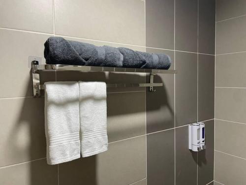 a towel rack in a bathroom with towels at Affordable Family Stay in Bangi in Kajang