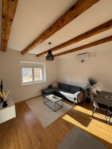 a living room with a black couch and a table at Apartment 107 in Cetinje