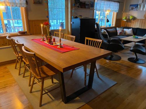 una mesa de madera con velas en la sala de estar en Fjällstuga i avskildhet, en Idre