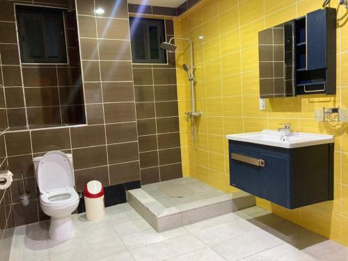 a bathroom with a toilet and a sink and a shower at Cereno Homes Accra in Accra