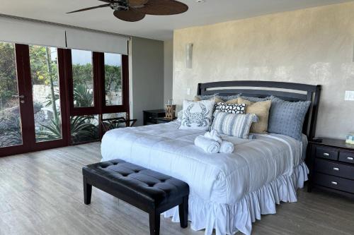een slaapkamer met een groot wit bed en een plafondventilator bij Happy Days Villa A in Fajardo