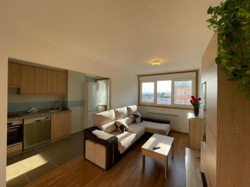 a living room with a couch and a table at APARTAMENTO NUEVO EN BURELA - A Mariña, Galicia in Burela de Cabo