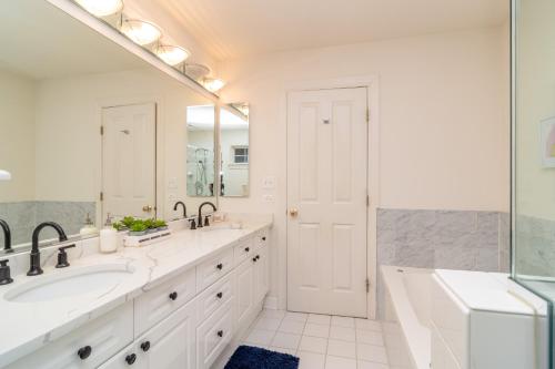 La salle de bains est pourvue de 2 lavabos et d'un grand miroir. dans l'établissement Beautiful 5br home for 14 guests with free parking, à Chicago