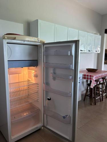 a refrigerator with its door open in a kitchen at Mirante do Lago in Capitólio