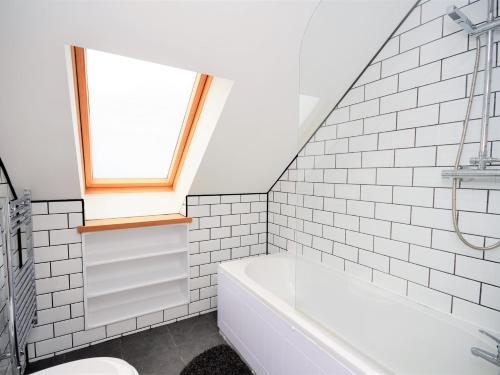 a bathroom with a bath tub and a window at 3 bed in Narberth 36799 