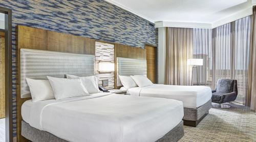 une chambre d'hôtel avec deux lits et une chaise dans l'établissement Mystic Lake Casino Hotel, à Prior Lake