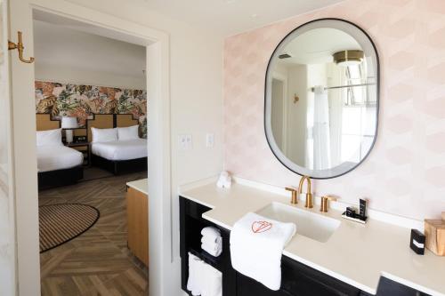 a bathroom with a sink and a mirror at La Concha Key West in Key West