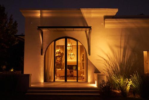 a house with a large glass door with a chandelier at Susana Balbo Winemaker´s House in Ciudad Lujan de Cuyo