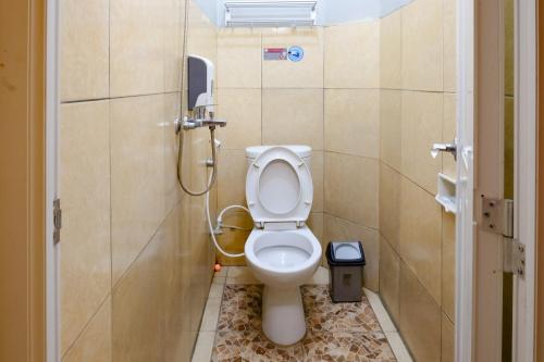 a bathroom with a toilet and a shower at Dya Hotel Boyolali in Boyolali
