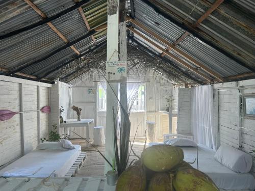 a room with two beds and a table in it at Punta Arena EcoHostal Coco in Playa Punta Arena