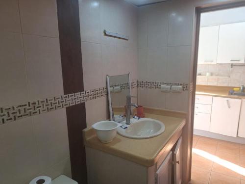 a bathroom with a sink and a mirror at Vista marina superior in Juan Pedro