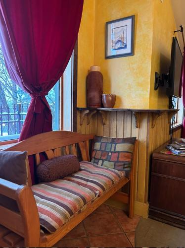 a bench sitting in a room with a window at Mistiso's Place Vacation Rentals in Nelson