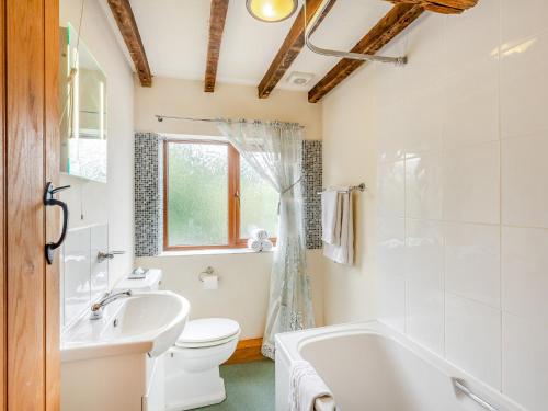 a bathroom with a tub and a sink and a toilet at 3 Bed in Bewdley THFIS in Highley