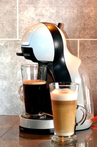 a coffee maker and two cups of coffee on a table at Hotel 33 in Blackpool