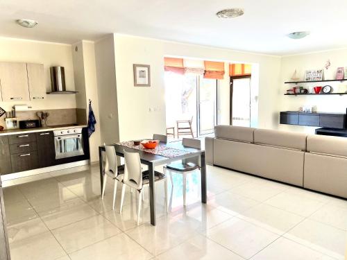 een keuken en eetkamer met een tafel en stoelen bij Delux 4 Stars Apartment Ariadne - 1 Min from Beach in Soline