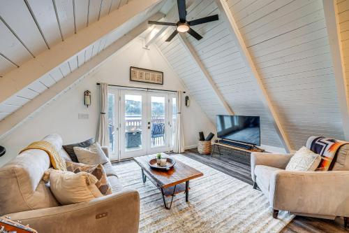 a living room with a couch and a table at Stylish Bellingham Home with Lake and Mountain Views! in Bellingham