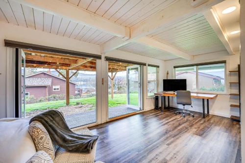 an empty living room with a desk and a computer at Stylish Bellingham Home with Lake and Mountain Views! in Bellingham