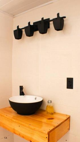 a bathroom with a black bowl sink on a wooden counter at Salamanca Loft in Los Güichiches
