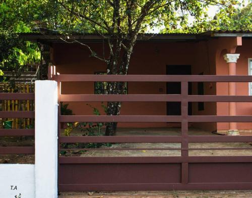 a fence in front of a house with a tree at Salamanca Loft in Los Güichiches