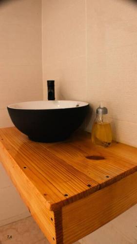 a black and white sink on a wooden table at Salamanca Loft in Los Güichiches