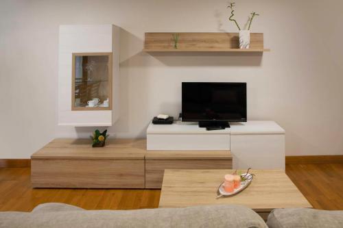 a living room with a flat screen tv on a stand at Apartamento Baztan Berri in Elizondo