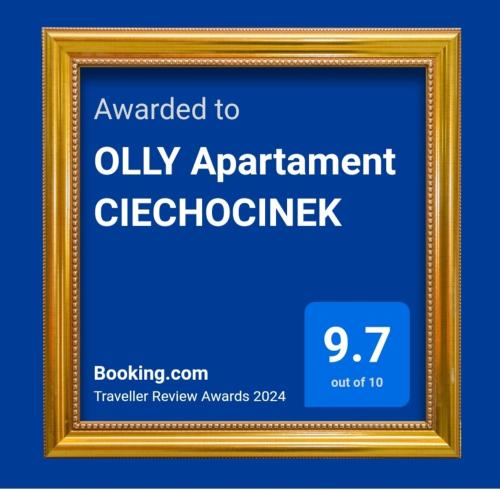 a sign with a gold picture frame with a clock at OLLY Apartament CIECHOCINEK in Ciechocinek