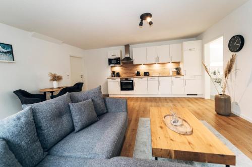 a living room with a couch and a table at Tor zur Altstadt in Husum