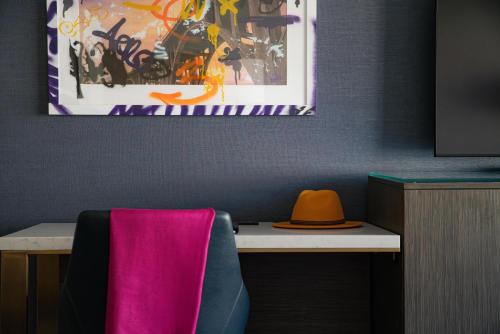 a hat sitting on top of a desk in a room at Hotel Dena, Pasadena Los Angeles, a Tribute Portfolio Hotel in Pasadena