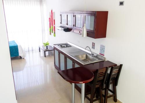 a kitchen with a sink and a counter top at Monterosa Apartamentos Amoblados in Pereira