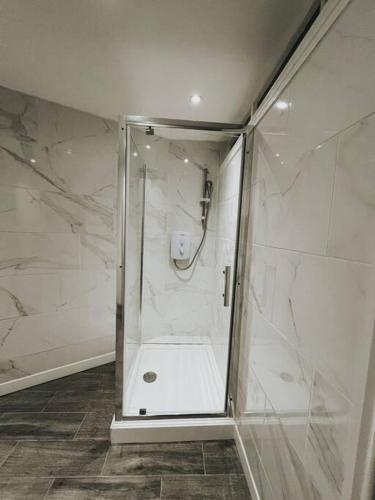 a shower with a glass door in a bathroom at Oldbury Heritage Hideaway! in Birmingham