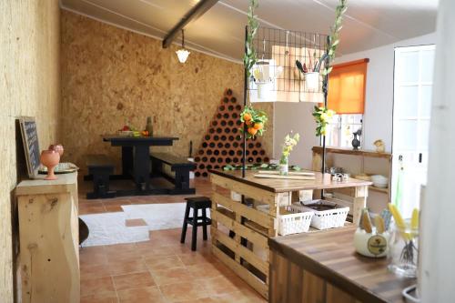 a kitchen with a table and a piano in a room at Refúgio Saloio- LugarTranquilo às Portas de Lisboa in Lousa