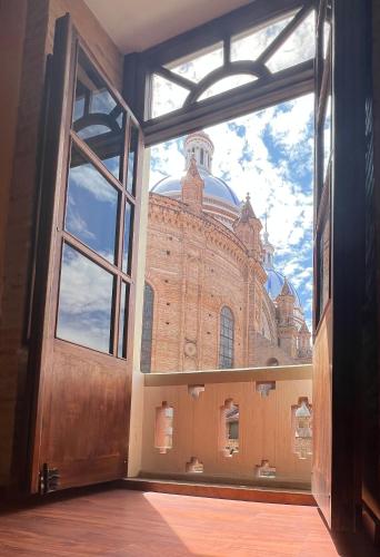 an open door to a large brick building at Floré Hotel Boutique Cuenca in Cuenca