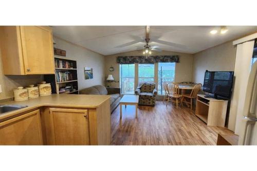 a kitchen and living room with a couch and a table at Westlake Dunes View Beach-FREE Pontoon Boat Rental in West Lake