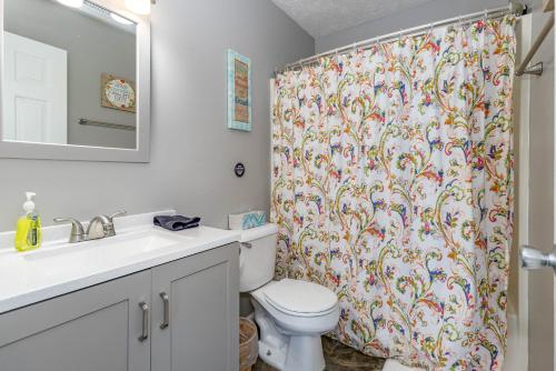 a bathroom with a toilet and a shower curtain at Bobby's Attached Home in Monroe in Monroe