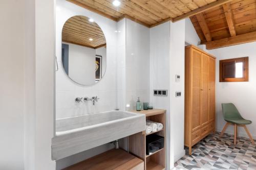 a bathroom with a large white tub and a mirror at Caleffa Triunfo 1 in Granada