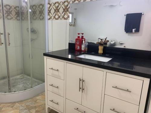 a bathroom with a sink and a shower at Vacation home rental in Georgetown