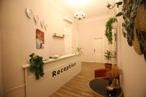 an office with a reception desk and plants at Malakan Boutique Nizami Hotel in Baku