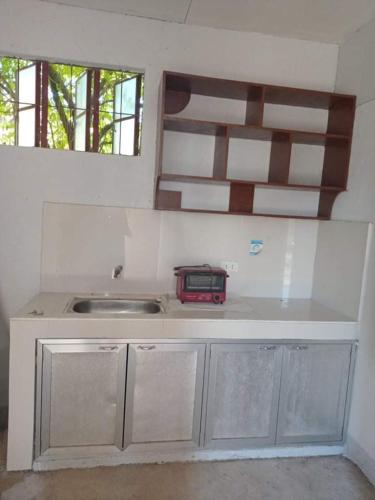 a kitchen with a sink and a counter top at APARTMENT FOR RENT in Baliuag