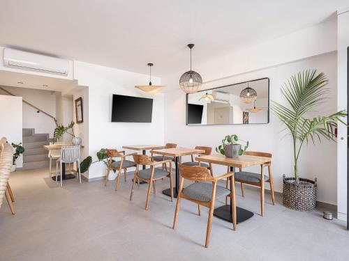a dining room with wooden tables and chairs at Calla Luxury Seafront Suites in Rethymno Town