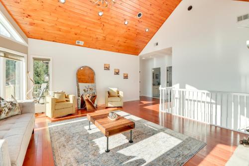 a living room with a wooden ceiling at Deck and Lake View Spacious Long Pond Home! in Long Pond