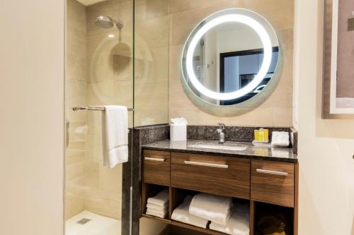 a bathroom with a sink and a mirror at Homewood Suites By Hilton Silao Airport in Silao