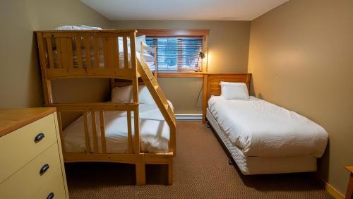 a bedroom with a bunk bed and a bunk ladder at Pinnacle Ridge Chalets by Fernie Lodging Co in Fernie