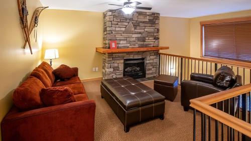a living room with a couch and a fireplace at Pinnacle Ridge Chalets by Fernie Lodging Co in Fernie