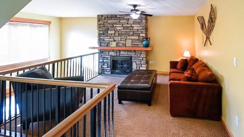 a living room with a couch and a fireplace at Pinnacle Ridge Chalets by Fernie Lodging Co in Fernie